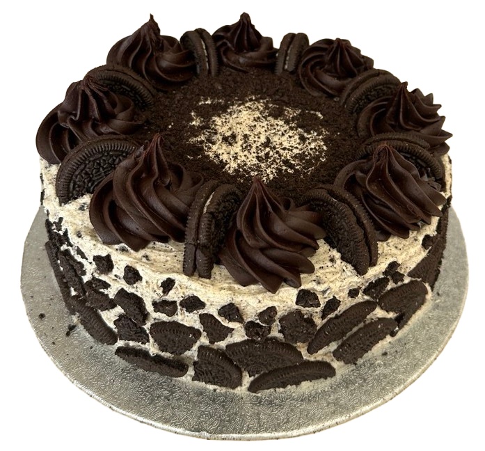A cookies-and-cream cake seen from above, with dark chocolate swirls, whole sandwich biscuits, and a dusting of crumbs in the centre.