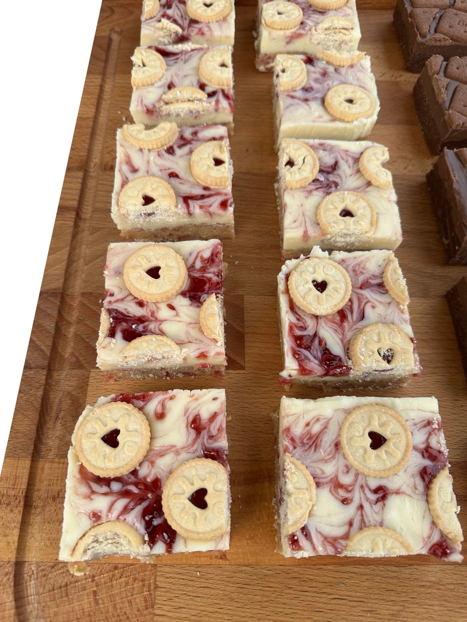 White chocolate squares marbled with red jam and finished with round biscuits that have a heart in the centre.