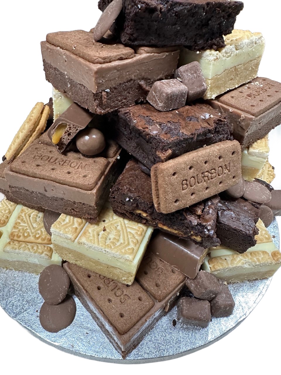Close view of a stacked brownie and biscuit tower, with chocolate pieces and bourbon biscuits pressed into the sides.